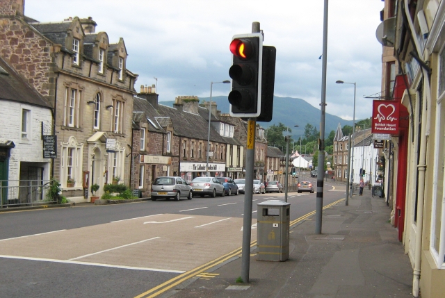 callander high street, a shop lined street with solid stone built houses
